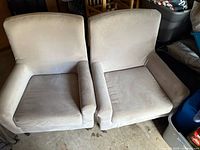 Front view of two matching beige armchairs