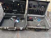 Open view of both tool cases showing interior pockets and hand tools