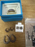 All items grouped: hoop earrings, ring, single earring