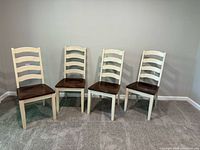 Four cream frame, brown seat dining chairs front view