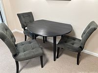 Drop-leaf table with leaves down on one side, chairs visible but not included