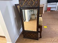 Front view showing entire framed mirror