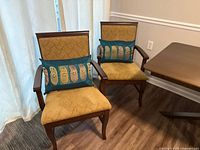 Front view of both dining chairs with pillows
