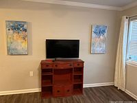 Wide view showing both framed artworks mounted on wall