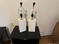 Front view of both white block-base lamps