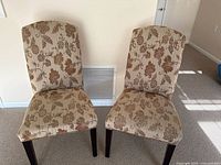 Front view of both upholstered floral chairs
