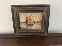 Front view of framed sailboat painting