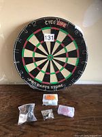 Front view of shrink-wrapped CyeeLife dartboard with accessory bags