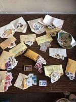 Overview of envelopes and loose Canadian stamps on tabletop