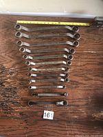 Full set of 12 wrenches arranged largest to smallest with tape for scale