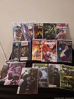 Front view showing all 15 bagged comics standing and laid out