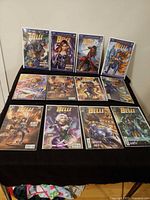All twelve Belle one-shot comic books displayed in three rows, each in protective bag with board