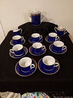Full set displayed showing coffee pot, sugar bowl, nine cups and saucers