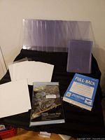 Group shot showing top-loaders, loose boards, sealed Full-Back pack, comic bags