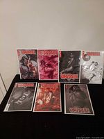 All seven bagged and boarded Vampirella comic books displayed upright showing various cover artworks.