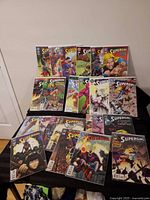 All twenty-three Supergirl comic issues displayed standing and laid out