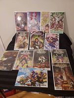 All 12 bagged Demon Days variant comics spread on table