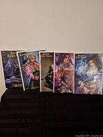 Five bagged Grimm Fairy Tales comics displayed upright