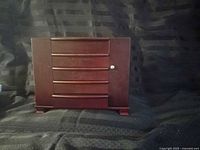 Closed dark wood jewelry case front view