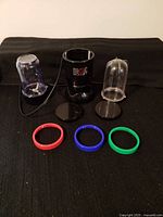 All components laid out: base, two cups, two lids, four drinking rings