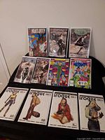 Full lot of 11 bagged Marvel comics displayed on stand and table