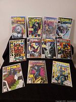 All eleven bagged and boarded Morbius comic books displayed on table