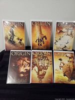 Front covers of all six bagged and boarded comics displayed