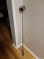 Full length view of Ping Rapture driver leaning against wall