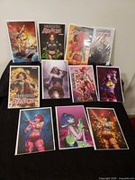 All items: five bagged Immortal Red Sonja comics and eight art prints displayed on table