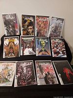 All twelve bagged and boarded John Constantine: Hellblazer issues 1-12 arranged in two rows on black surface