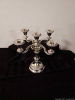 Front view of silver five-arm candelabra