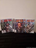 Six bagged and boarded Swamp Thing Brightest Day Aftermath comics displayed on black surface