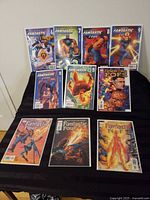 All ten comics arranged on black cloth showing covers