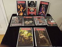 Nine bagged and boarded Vampirella comic books displayed on surface