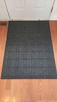 First doormat on hardwood floor showing overall design and size