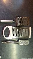 All three handheld graters laid out showing sizes and handles