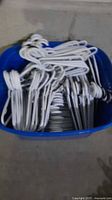 Storage bin full of plastic hangers