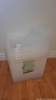 Front view of clear storage bin with lid and label