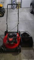 Full view of red Craftsman push mower with handle and grass bag