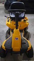 Front view of Cub Cadet riding lawn mower showing steering wheel, seat, deck
