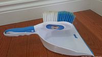 Brush resting inside dustpan, shows overall design and color