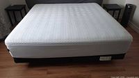 Full view of king mattress with cover on frame