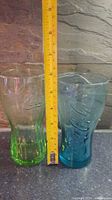 Front view of both glasses with ruler showing height