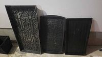 Three black boot trays side by side showing designs