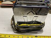 Front and side view of toaster showing chrome body and cord