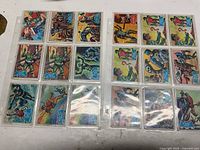 Fronts of 18 Batman and Robin trading cards in two sleeves