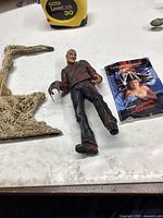 Figure, base, and poster card displayed on tabletop