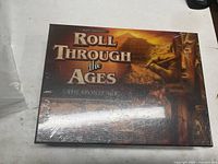 Front of sealed Roll Through the Ages board game