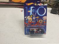 Front view of sealed Hot Wheels Looney Tunes 100 WB '77 Dodge Van on card