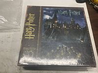 Front of sealed Harry Potter jigsaw puzzle box displaying Hogwarts artwork and piece count